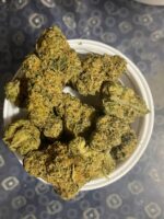 Wedding Cake weed strain 7 g pack on a dish with frosty, crystal-covered buds, UK edition